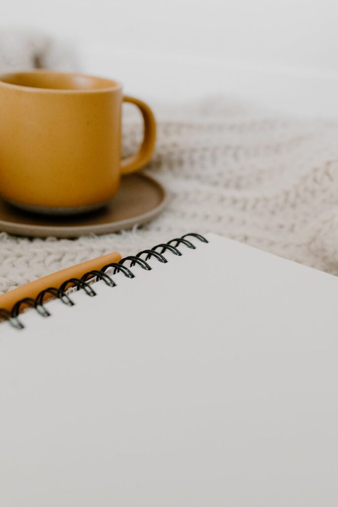 a blank page of spiral notebook on white textile